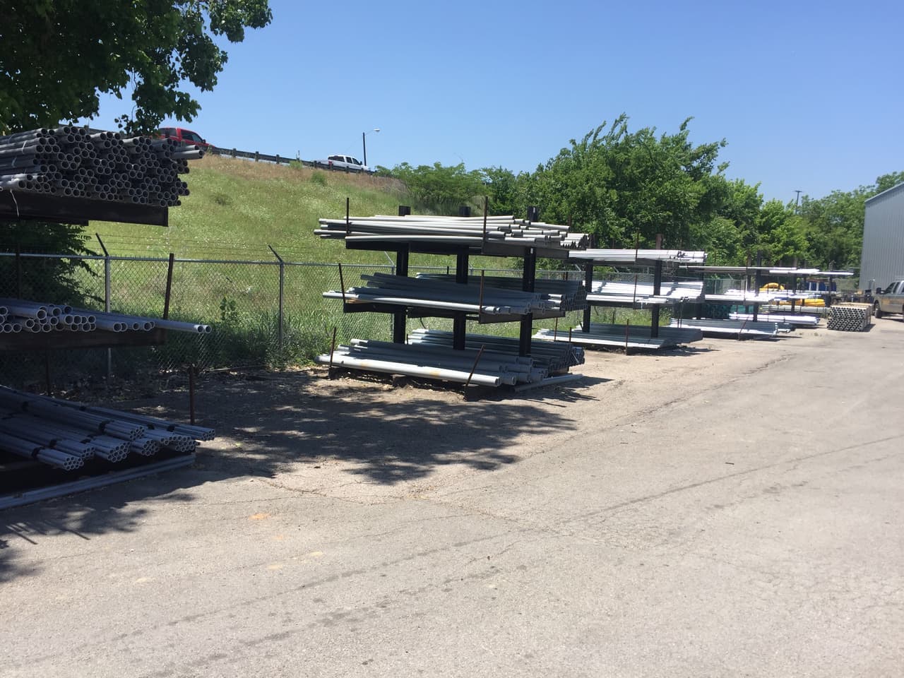 Outdoor racks of gray electrical conduit beside the Smith Supply yard in Stephenville, TX