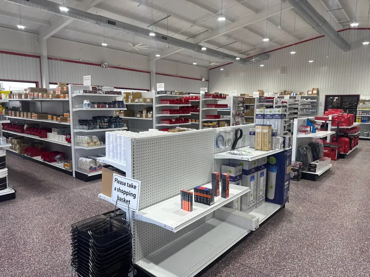 Stocked shelving, water filters and red tool cases inside the Smith Supply store in Godley, TX